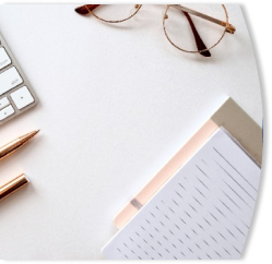 desk with glasses and notepad